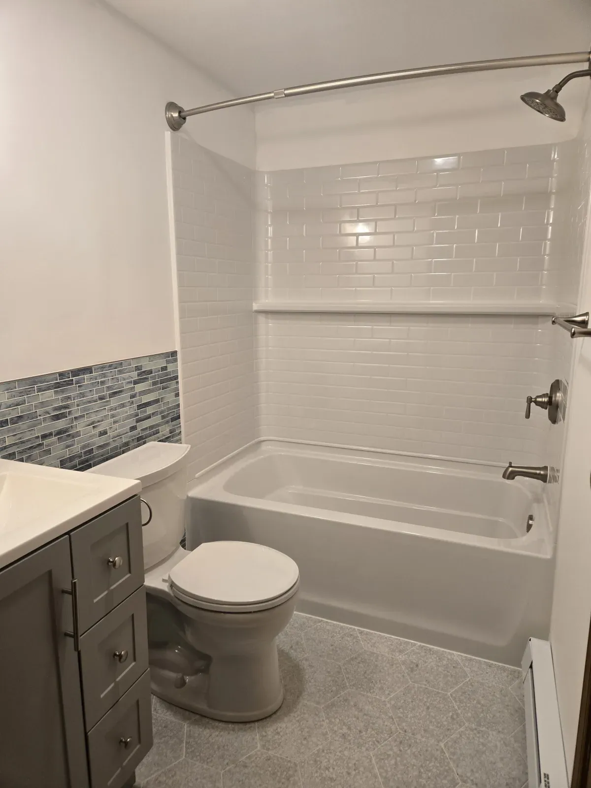 Clean white acrylic shower with black fixtures
